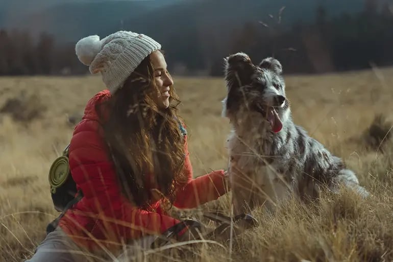 a girl with her dog in the countryside