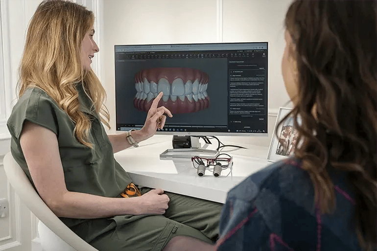 a dentist showing a patient an image of her smile