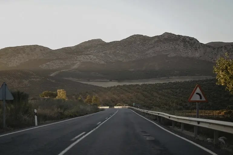 a road with mountains in the background