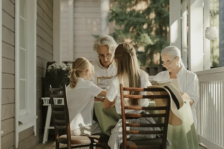 grandparents and grandchildren reading and doing crafts