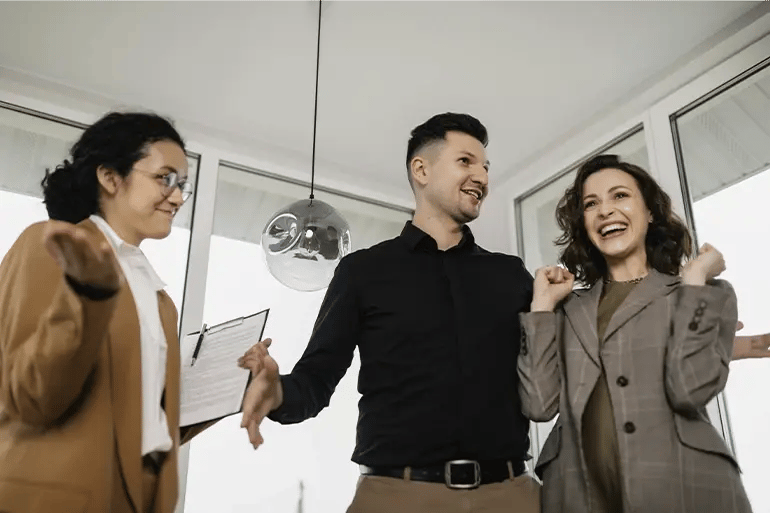 three people in suits, one of them very pleased to have signed a rental agreement