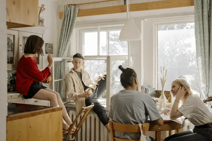 a group of lads having a chat in the kitchen of a house