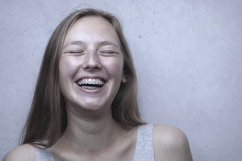 a girl smiling with braces