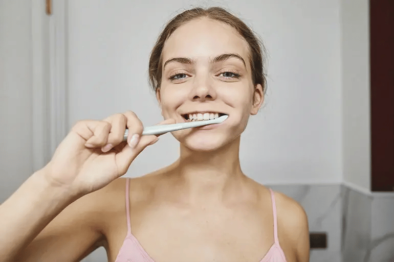 a girl brushing her teeth