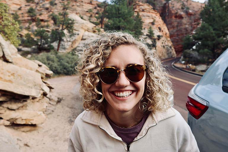 girl smiling with no damaged tooth enamel