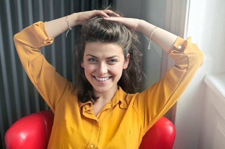 woman smiling because of orthodontic coverage in Spain