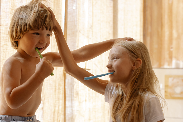 children brushing their teeth thinking of dental care insurance