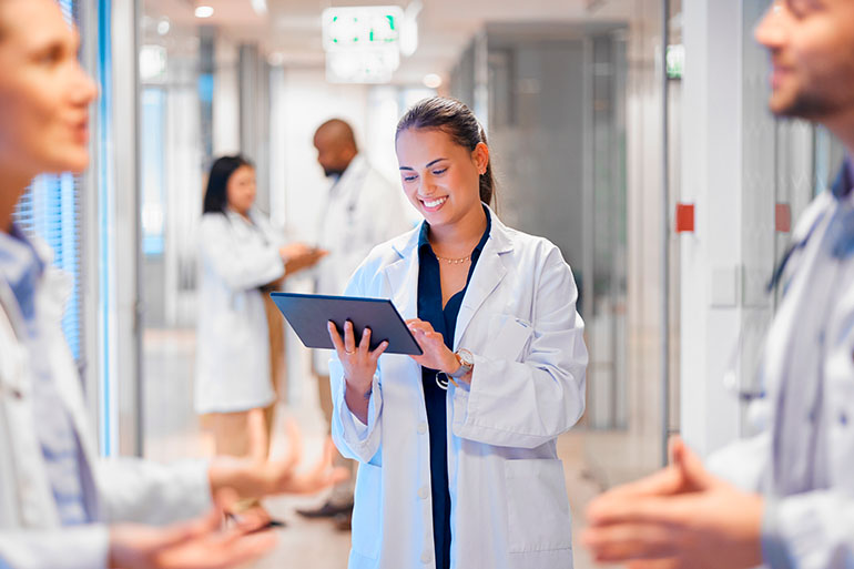 doctor smiling reading about expat private health insurance