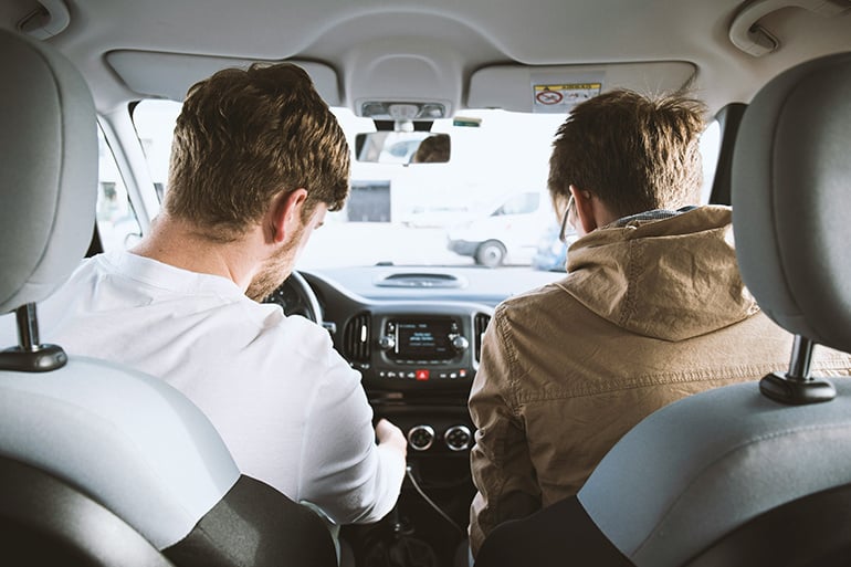 A friend explains to others about his auto insurance that covers hit-and-run accidents.