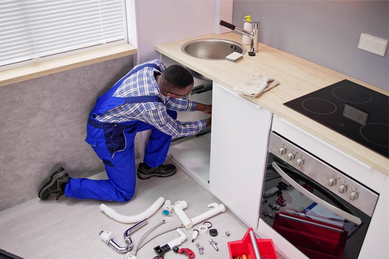 A man fixing a breakdown thanks to having water damage home insurance.