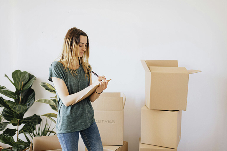 A woman moving into her new home after obtaining the residence permit to buy a property in Spain.