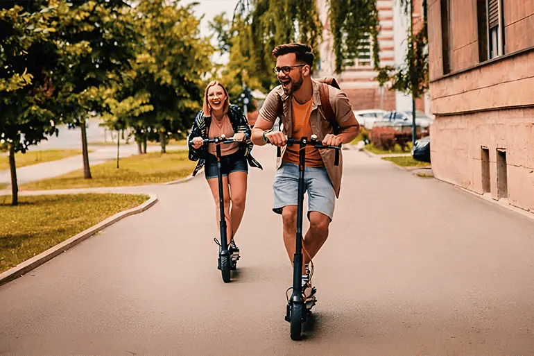 A couple enjoying their ride after purchasing their electric scooter insurance.