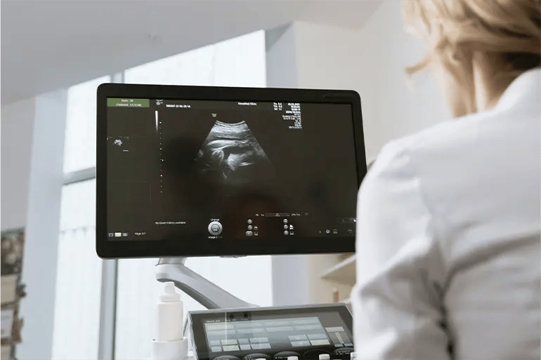 A doctor checking that the pregnancy is going well after the parents hired medical insurance for pregnancy.