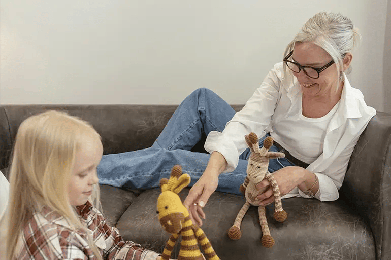  A grandmother playing with her granddaughter after getting her retirement health insurance plan.