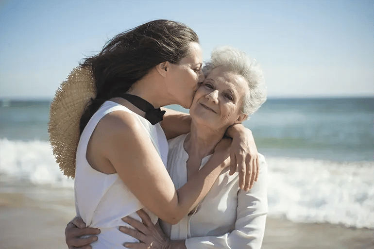 A daughter and her mother enjoying themselves after purchasing their life insurance in Spain.