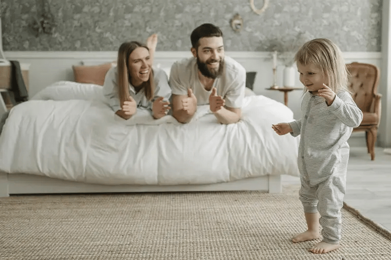 A family laughing after finding out the average cost of health insurance for a family of 3.