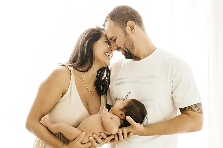 A happy family after learning about the list of essential items for their newborn baby.