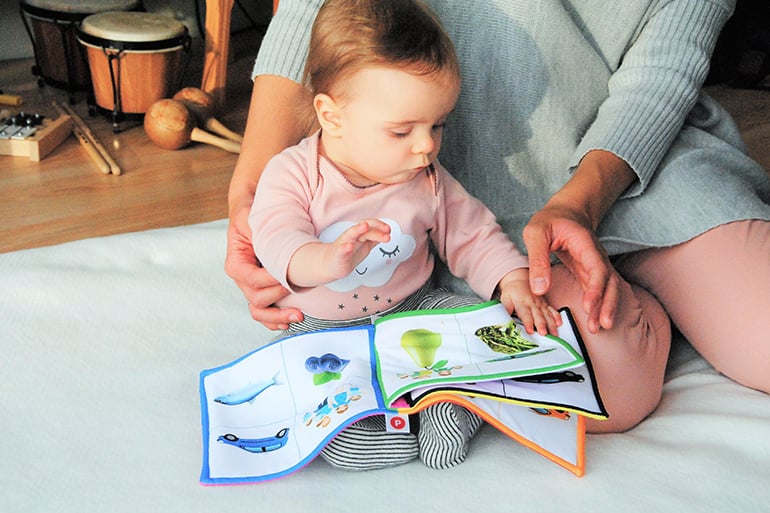 mom reading about newborn baby essentials