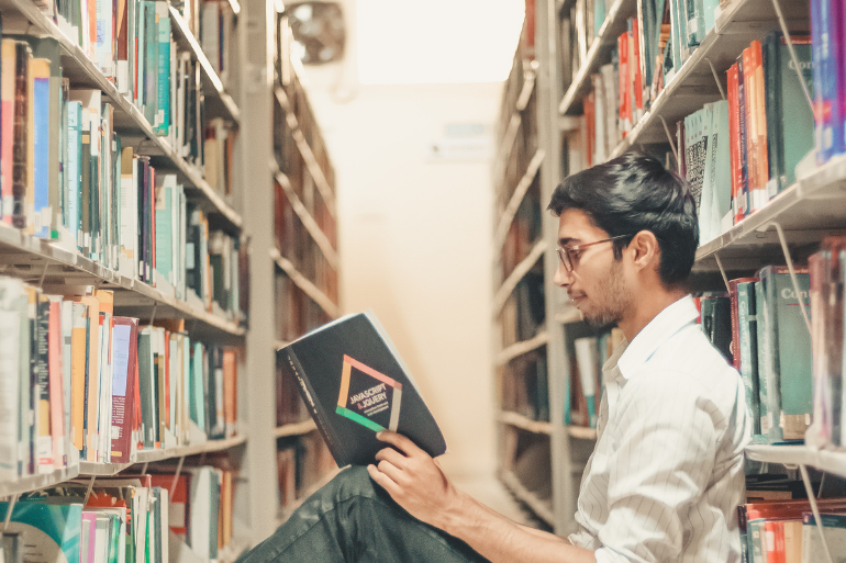 man reading a book while studying in Spain after Brexit