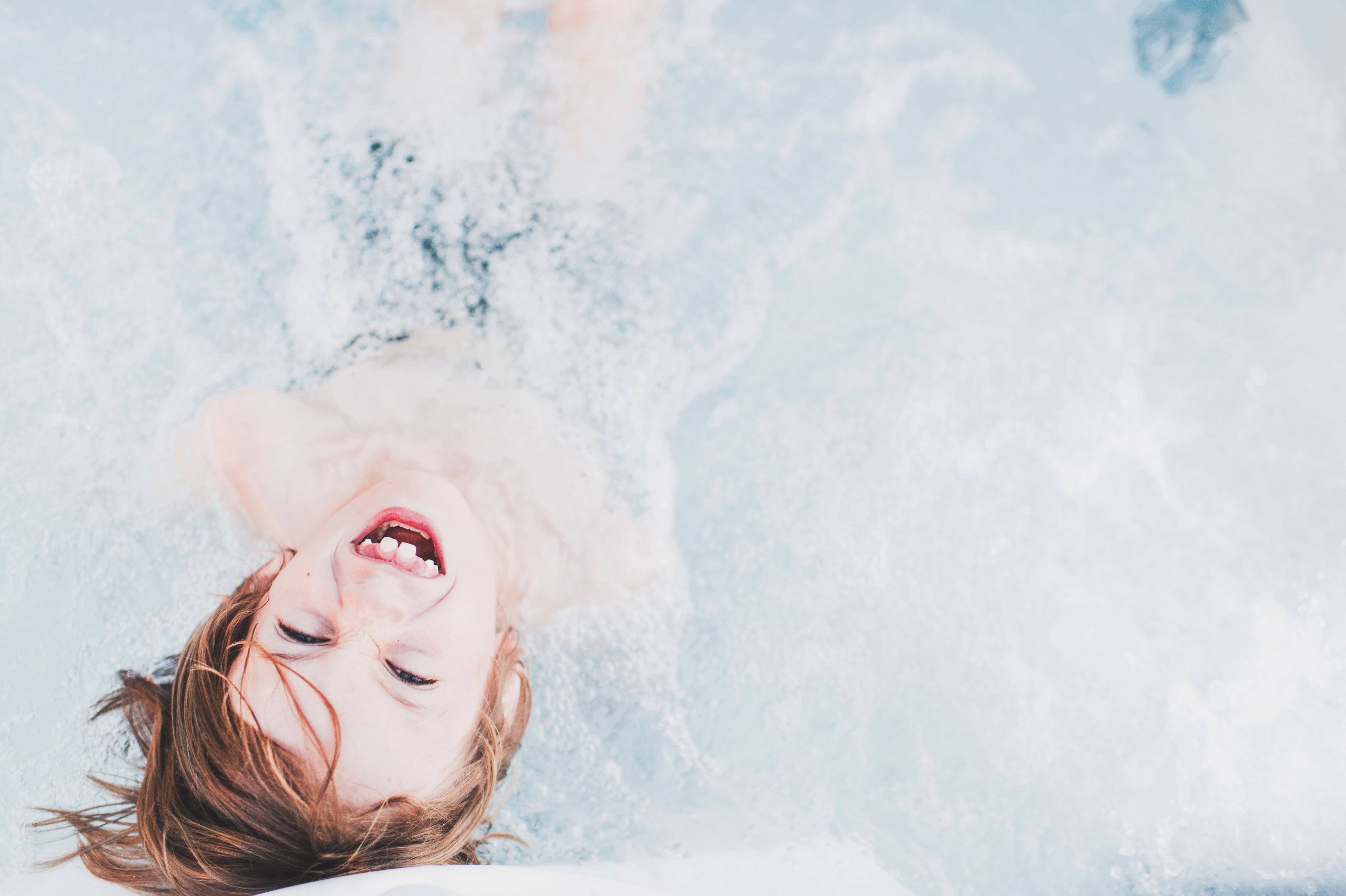 kid in the ocean with family insurance plans