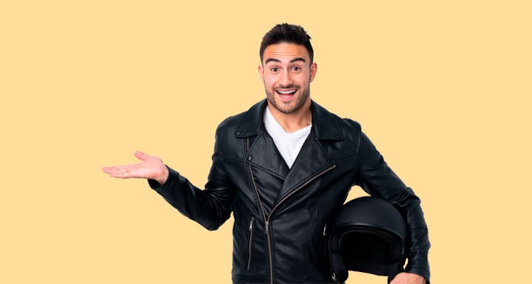 A young man wearing a black jacket and a motorbike helmet.