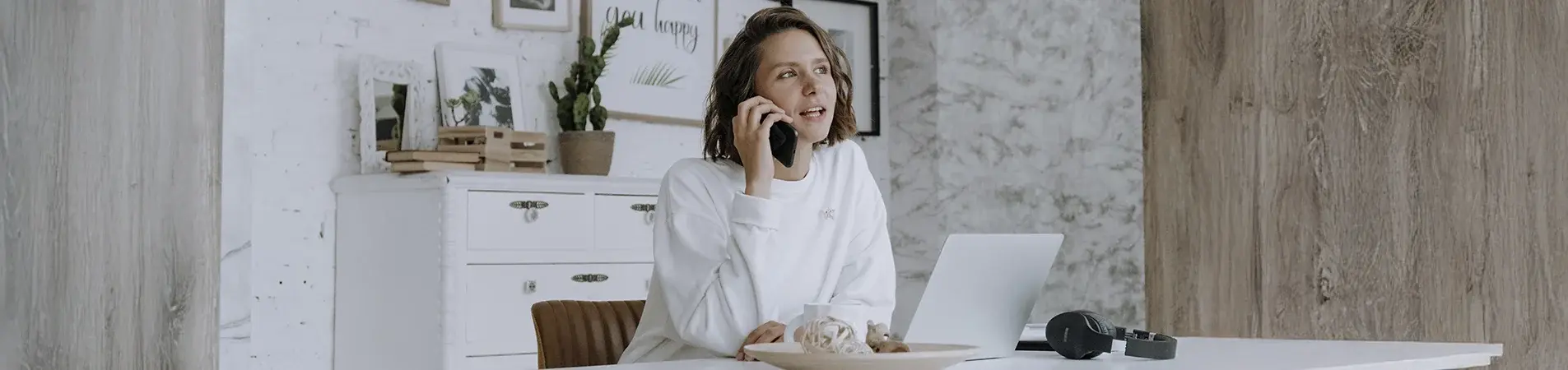 a woman working from her office talking on the telephone