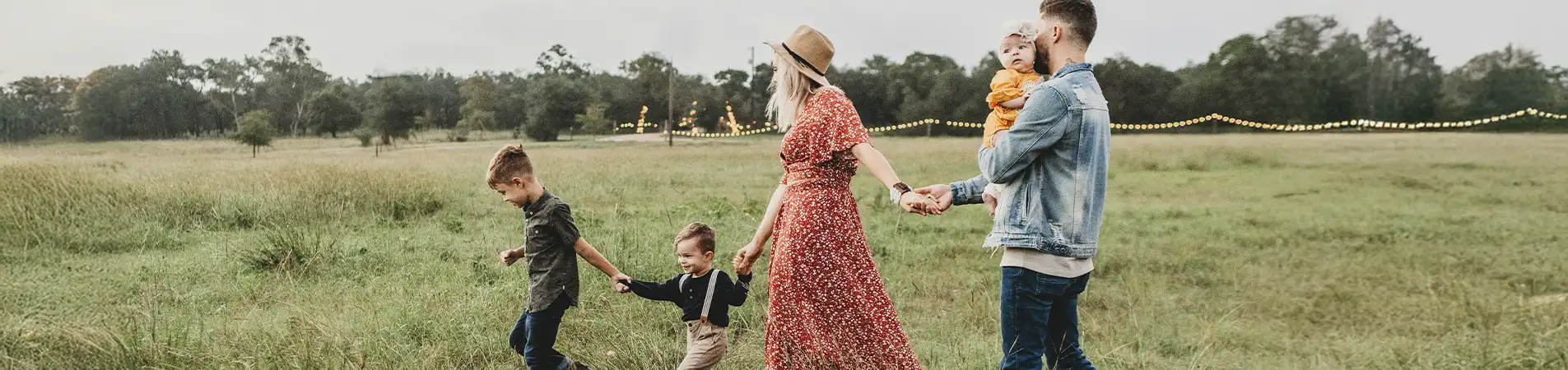 a family in a field, two children and two adults