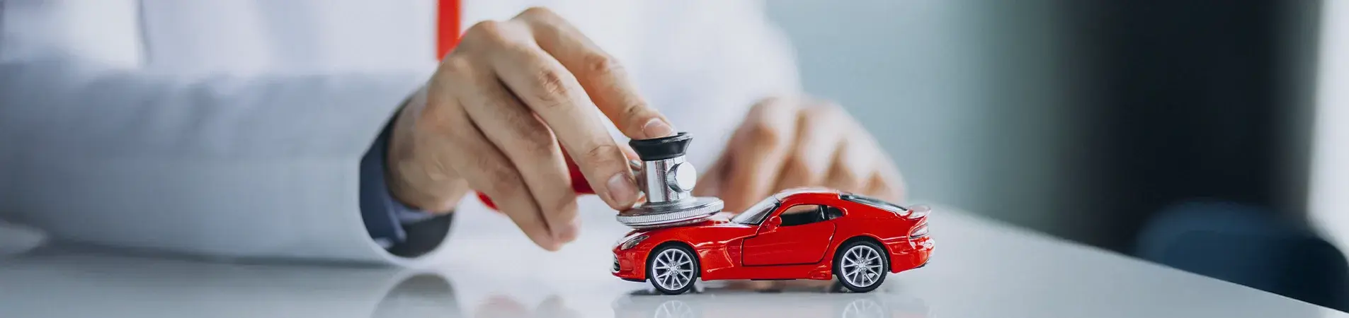 a doctor listening to a toy car with a stethoscope