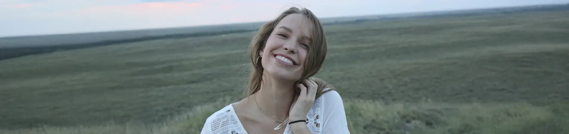 a girl smiling in the mountains