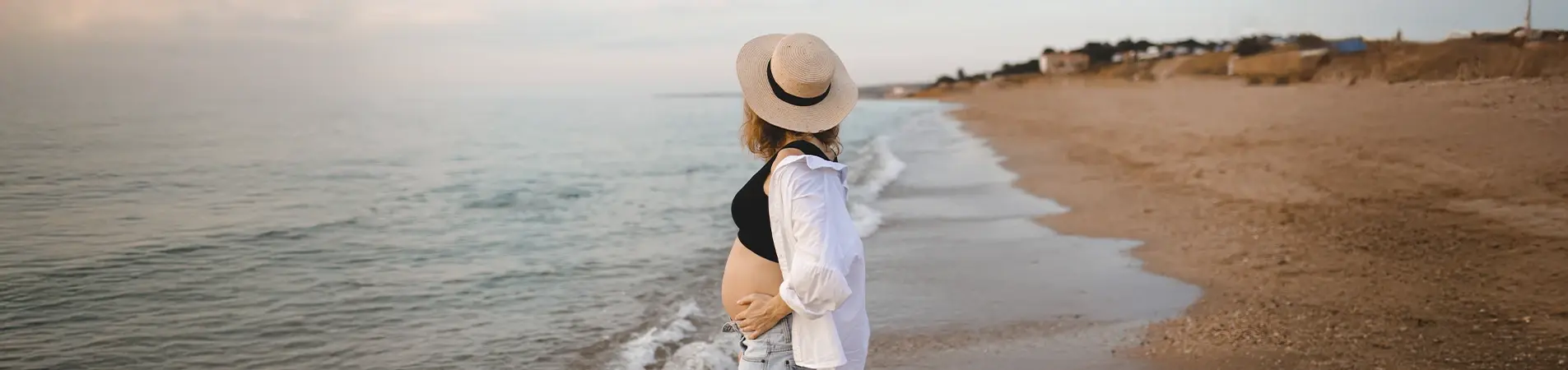 A woman enjoying her vacation after getting her travel insurance and pregnancy coverage.