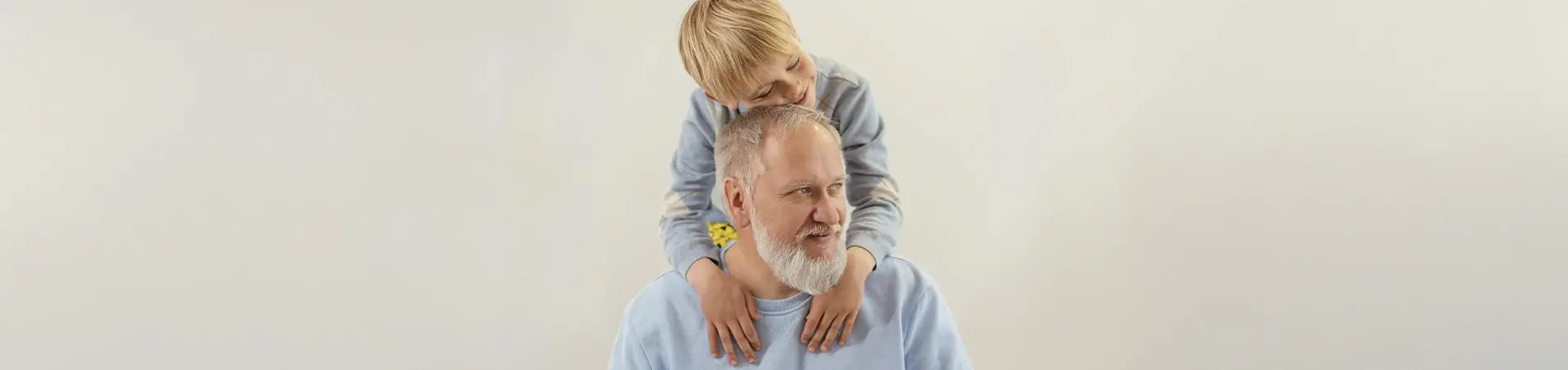 A grandfather enjoying time with his grandson after taking out his retirement health insurance plan.