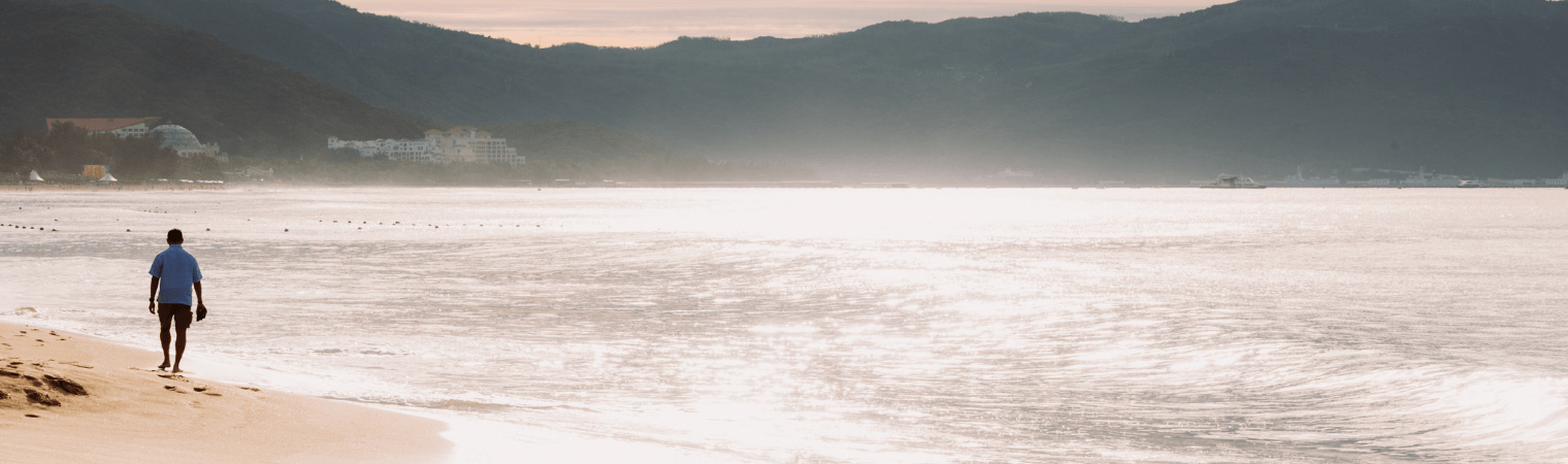 man walking beach